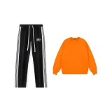 Black pants + orange sweatshirt